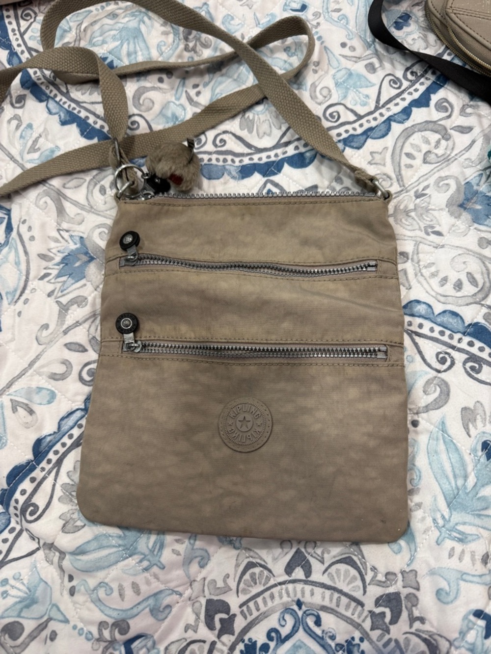 Taupe Kipling crossbody with Multi-Zip Pockets.